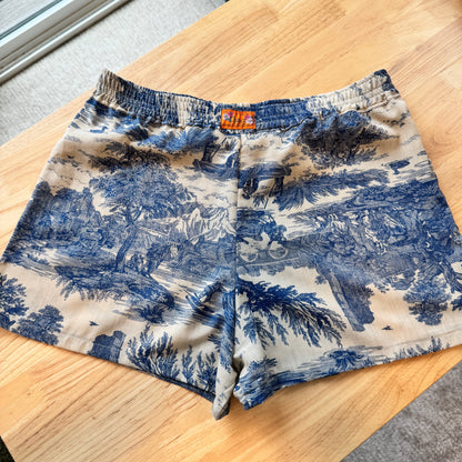 Blue and white patterned shorts on a wooden table