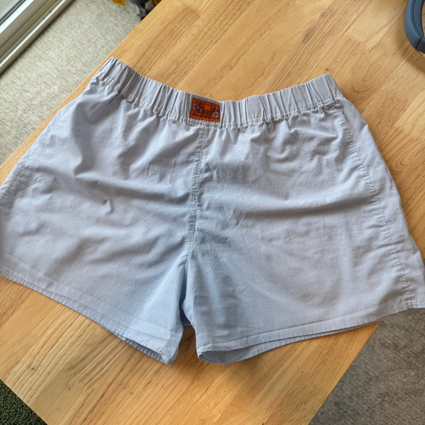 Light blue shorts on a wooden table